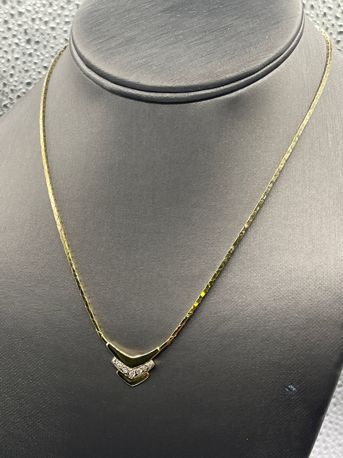 14kt yellow gold Ladies Chevron shaped diamond necklace with a cobra link chain