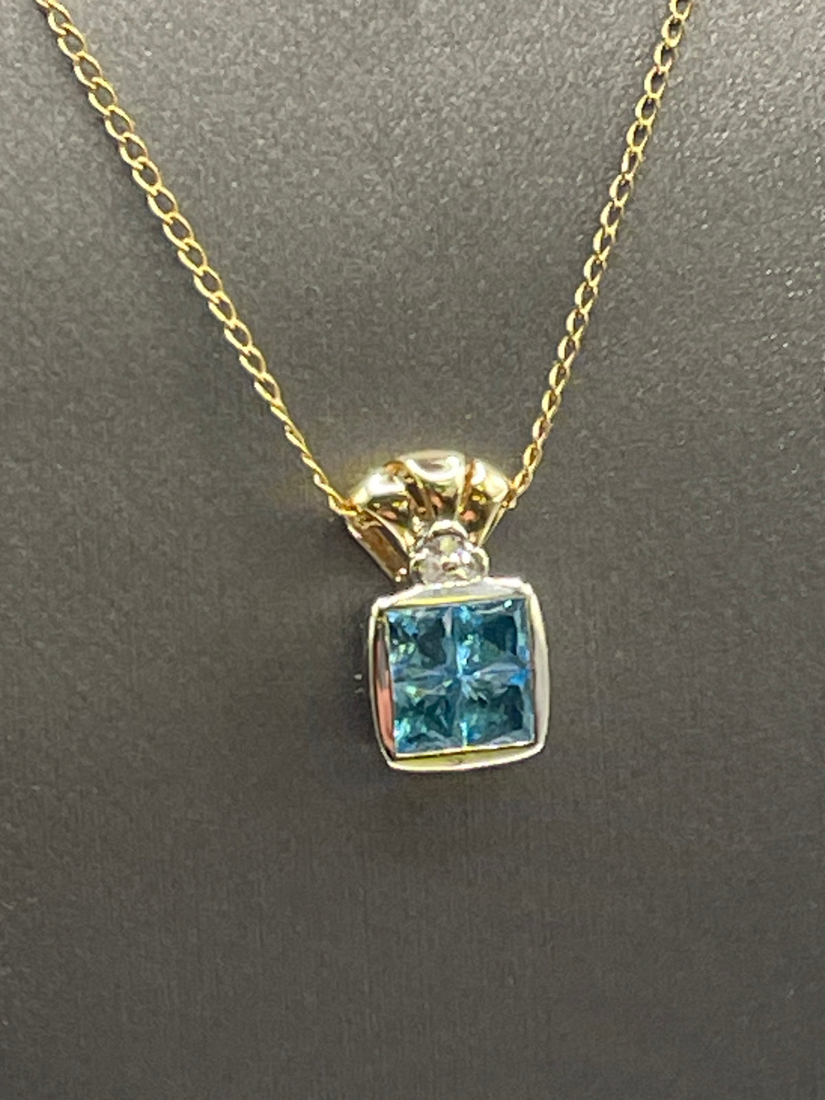 Ladies 14 Karat Solid Two-Toned Gold Blue Topaz and Diamond Pendant