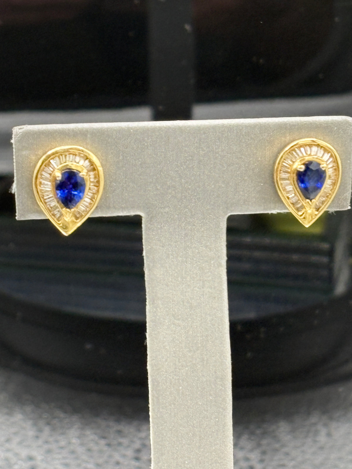 14kt Ladies tear drop shaped sapphire and diamond baguette earrings a diamond halo surrounding