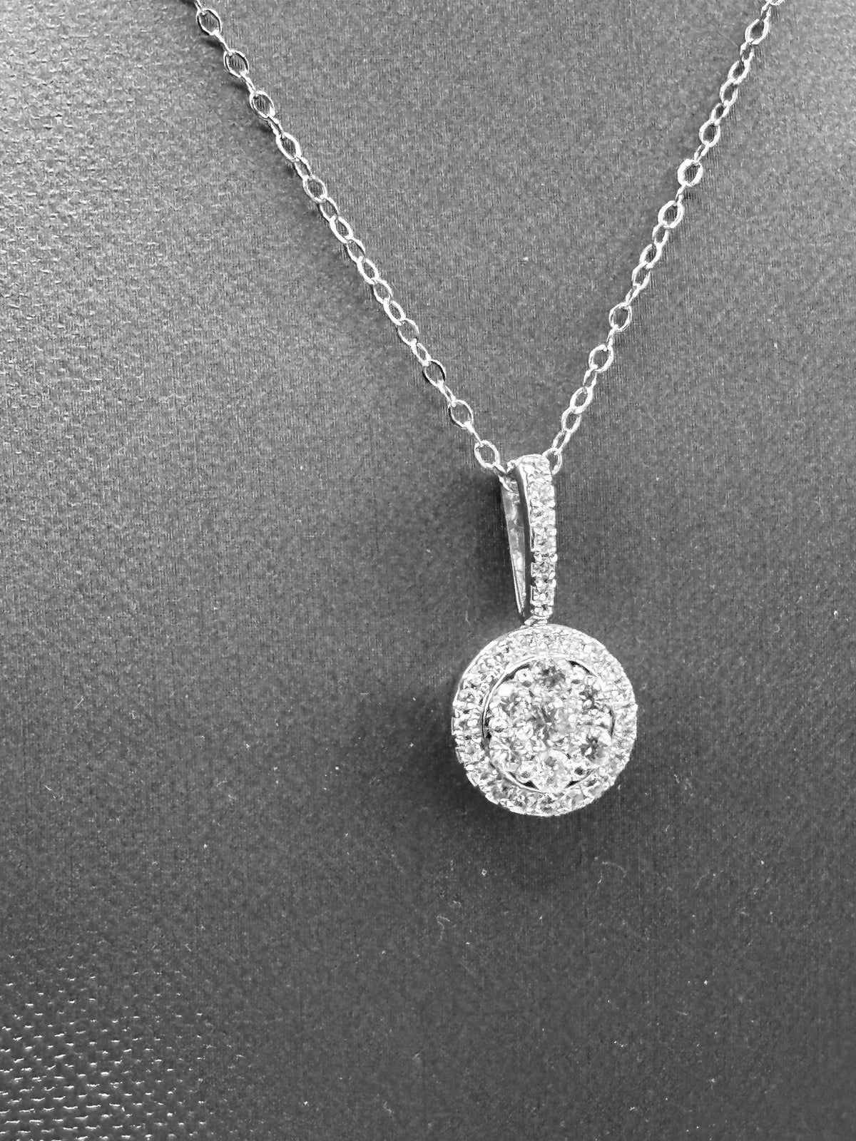 14kt solid white gold, ladies diamond cluster pendant with diamond halo and diamond bale, hanging from a 16’’ pendant chain