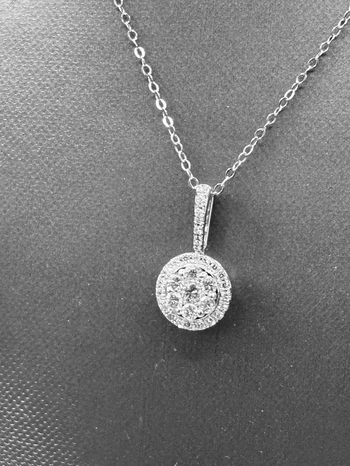 14kt solid white gold, ladies diamond cluster pendant with diamond halo and diamond bale, hanging from a 16’’ pendant chain