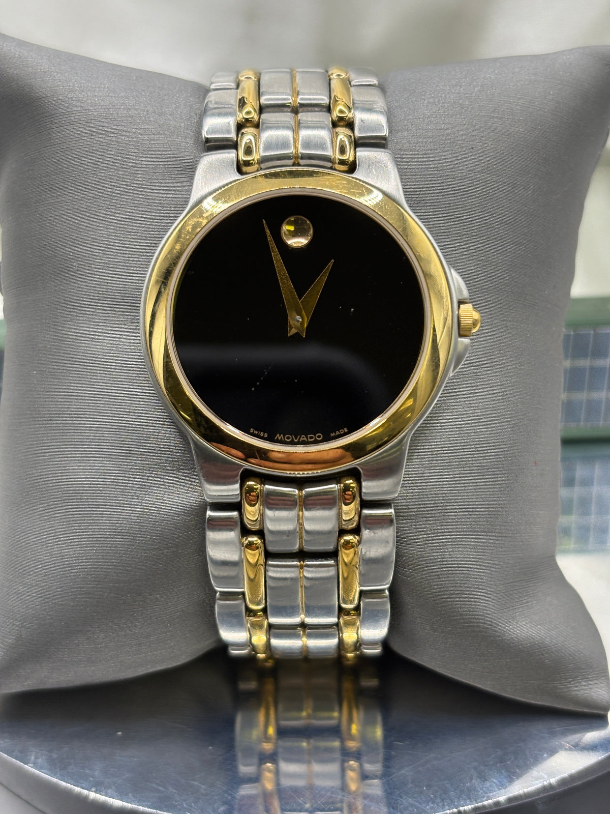 Vintage Movado Mens museum watch with a black dial, two tone yellow and stainless steel bracelet