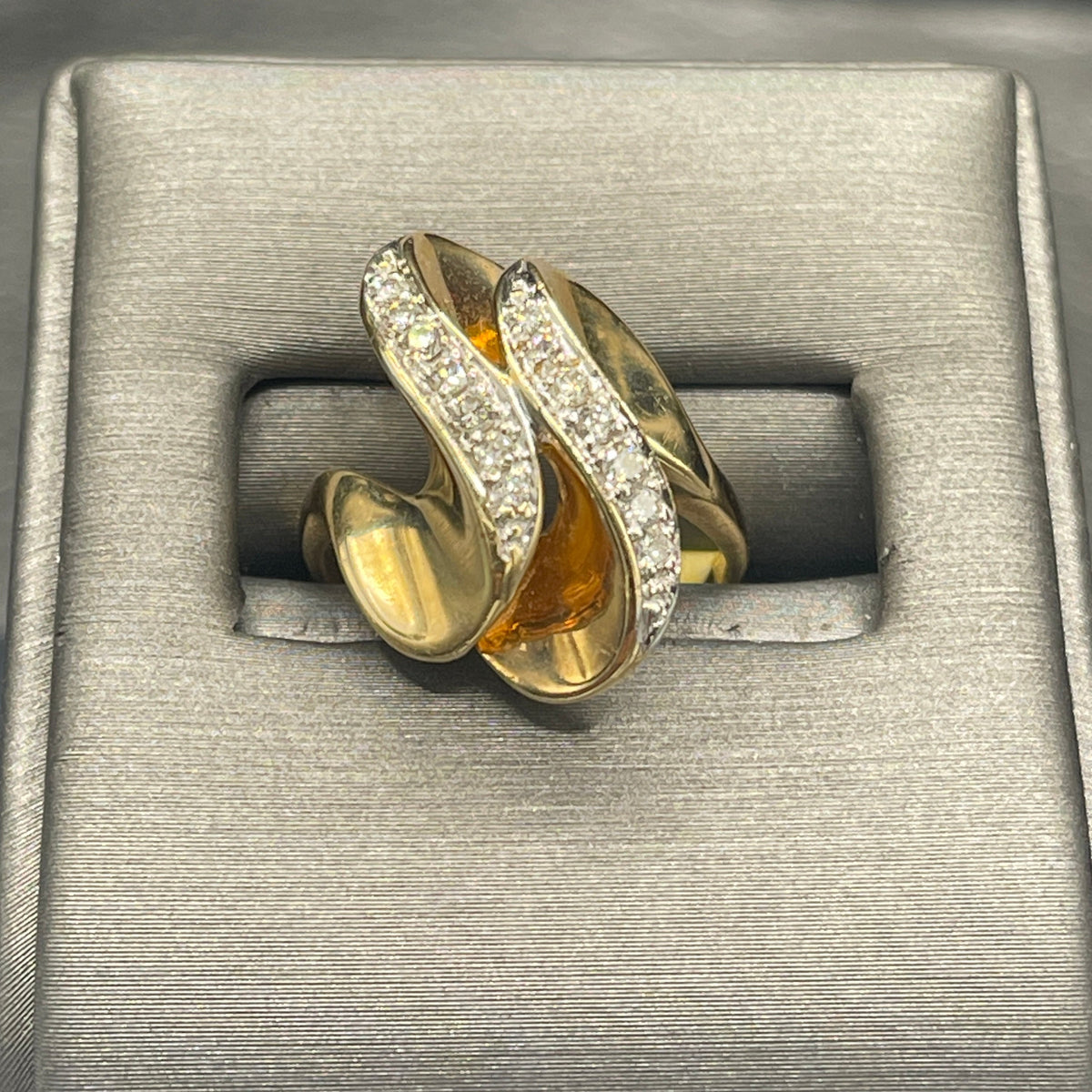 A Ladies 14 Karat Yellow Gold Double Diamond Swirl Cocktail Ring