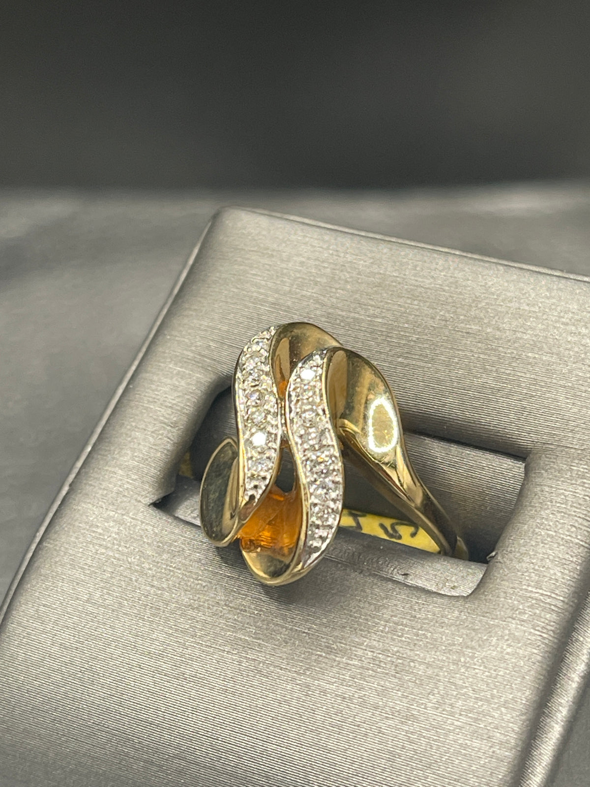 A Ladies 14 Karat Yellow Gold Double Diamond Swirl Cocktail Ring