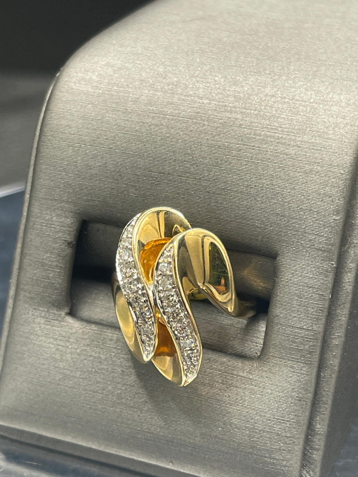 A Ladies 14 Karat Yellow Gold Double Diamond Swirl Cocktail Ring