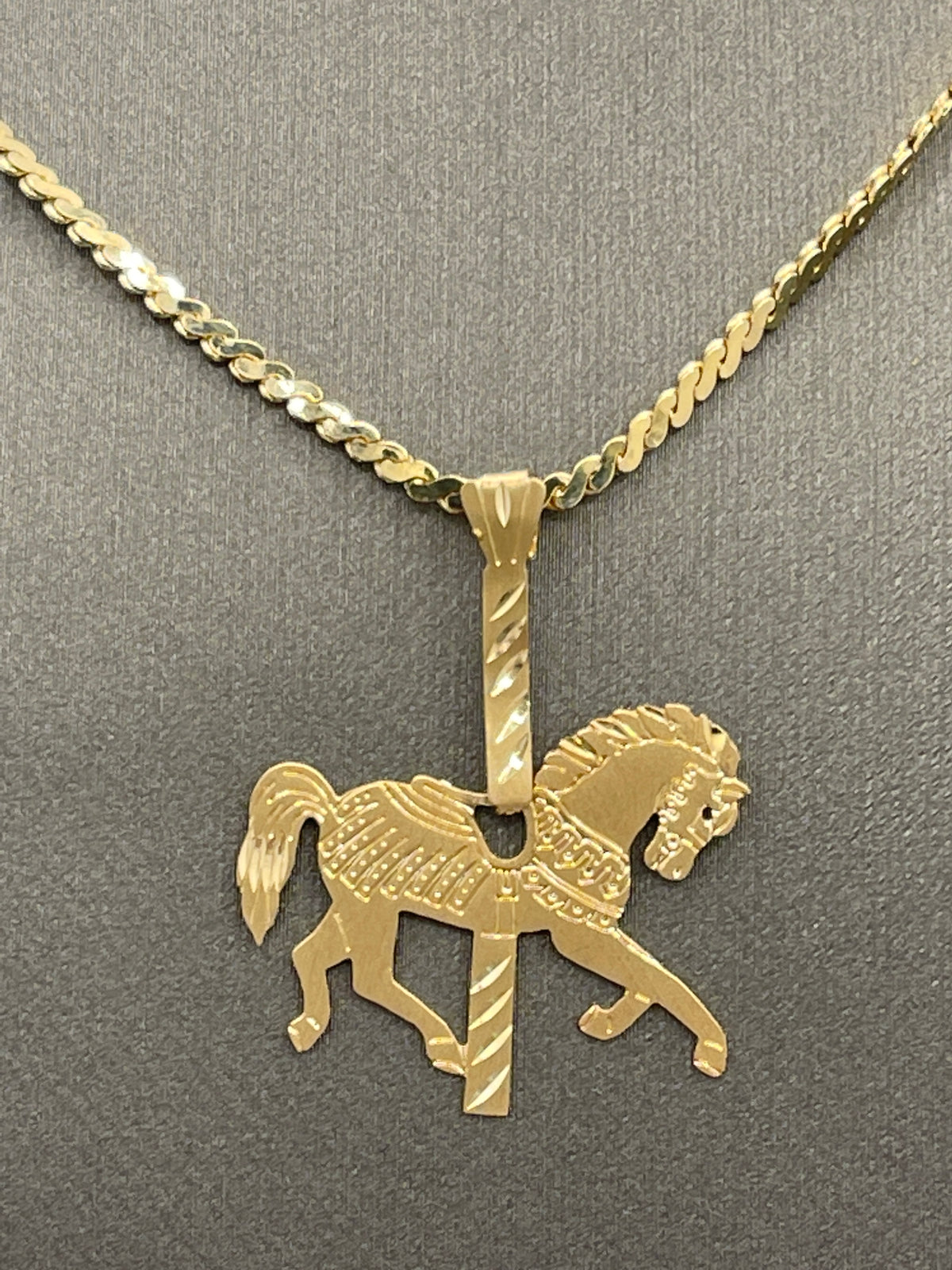 A Ladies Vintage Michael Anthony14 Karat Yellow Gold Carousel Horse Pendant