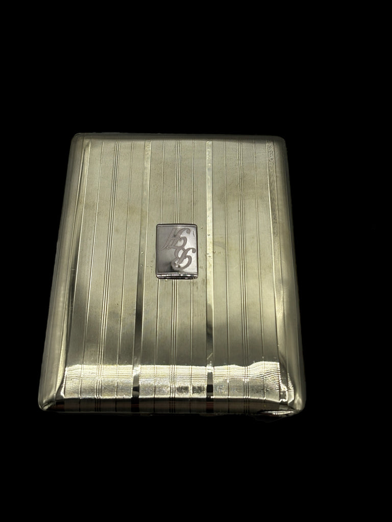 Silver cigarette case with a logo on a black background