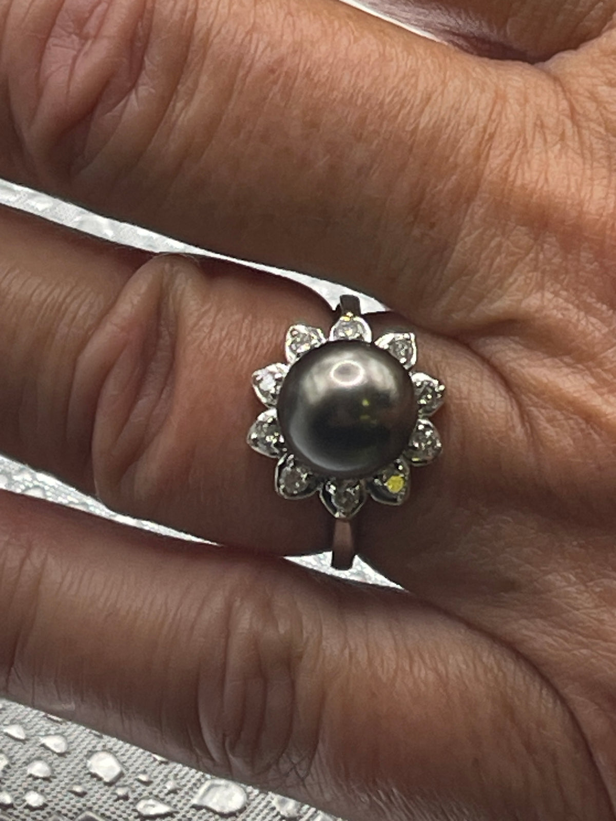 A Beautiful Ladies 14 Karat White Gold Diamond and Black Pearl Ring
