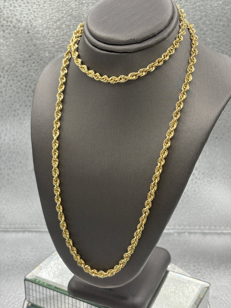 Gold chain on a gray stand with a neutral background
