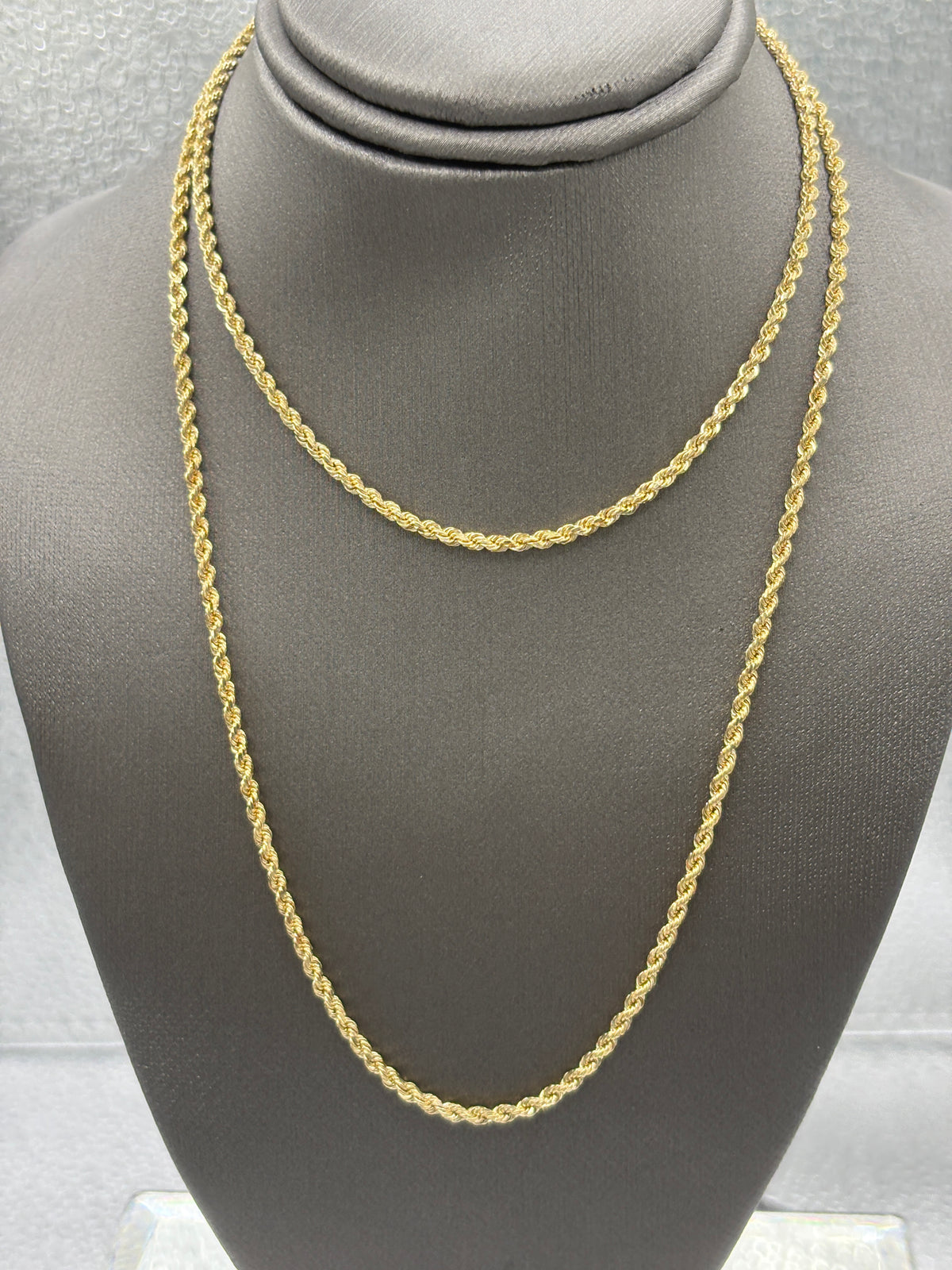 Gold chain on a gray mannequin bust