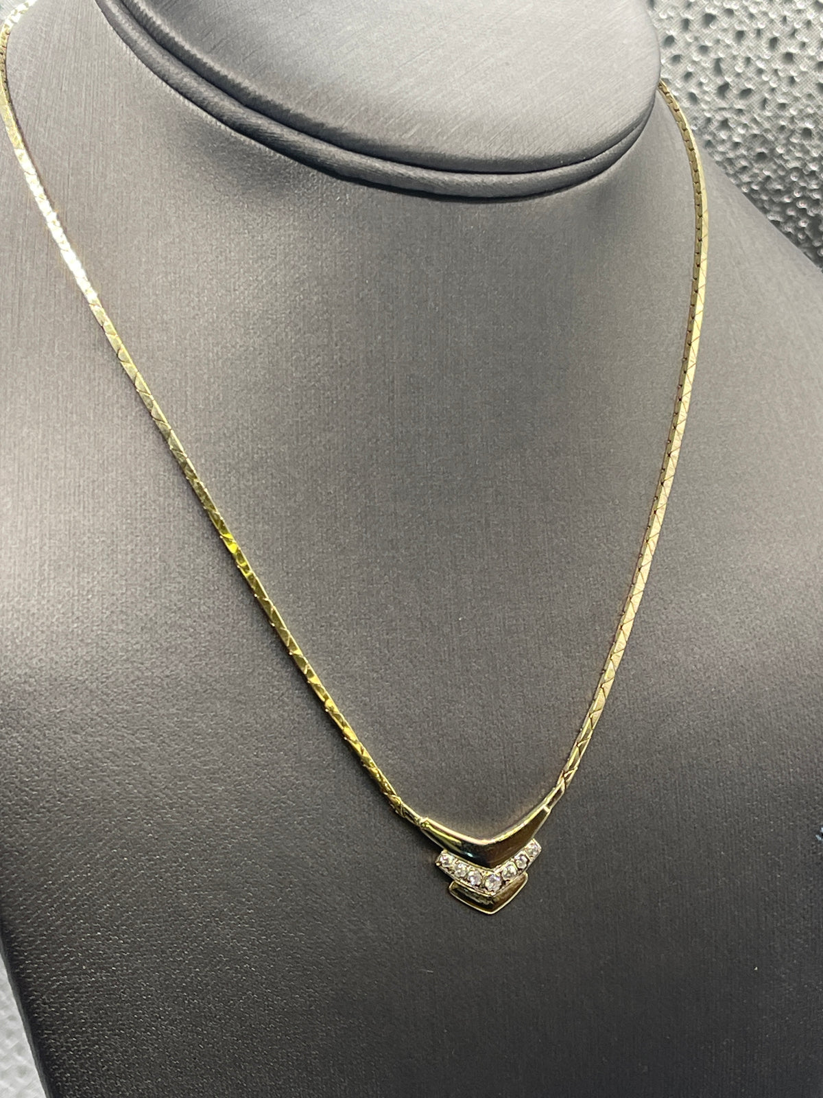 14kt yellow gold Ladies Chevron shaped diamond necklace with a cobra link chain