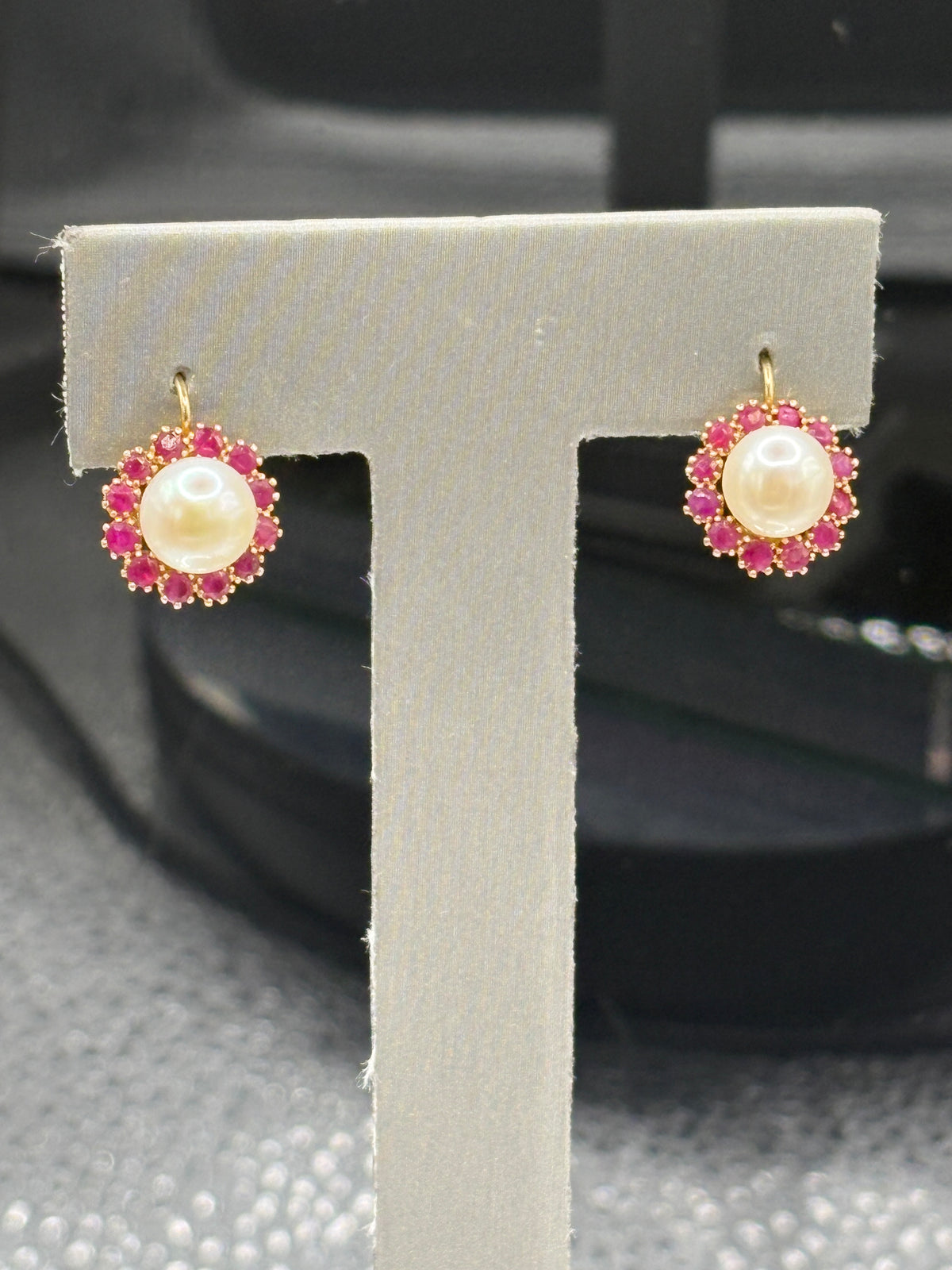 14kt Ladies Pearl earrings with a Ruby halo encircling the Pearls