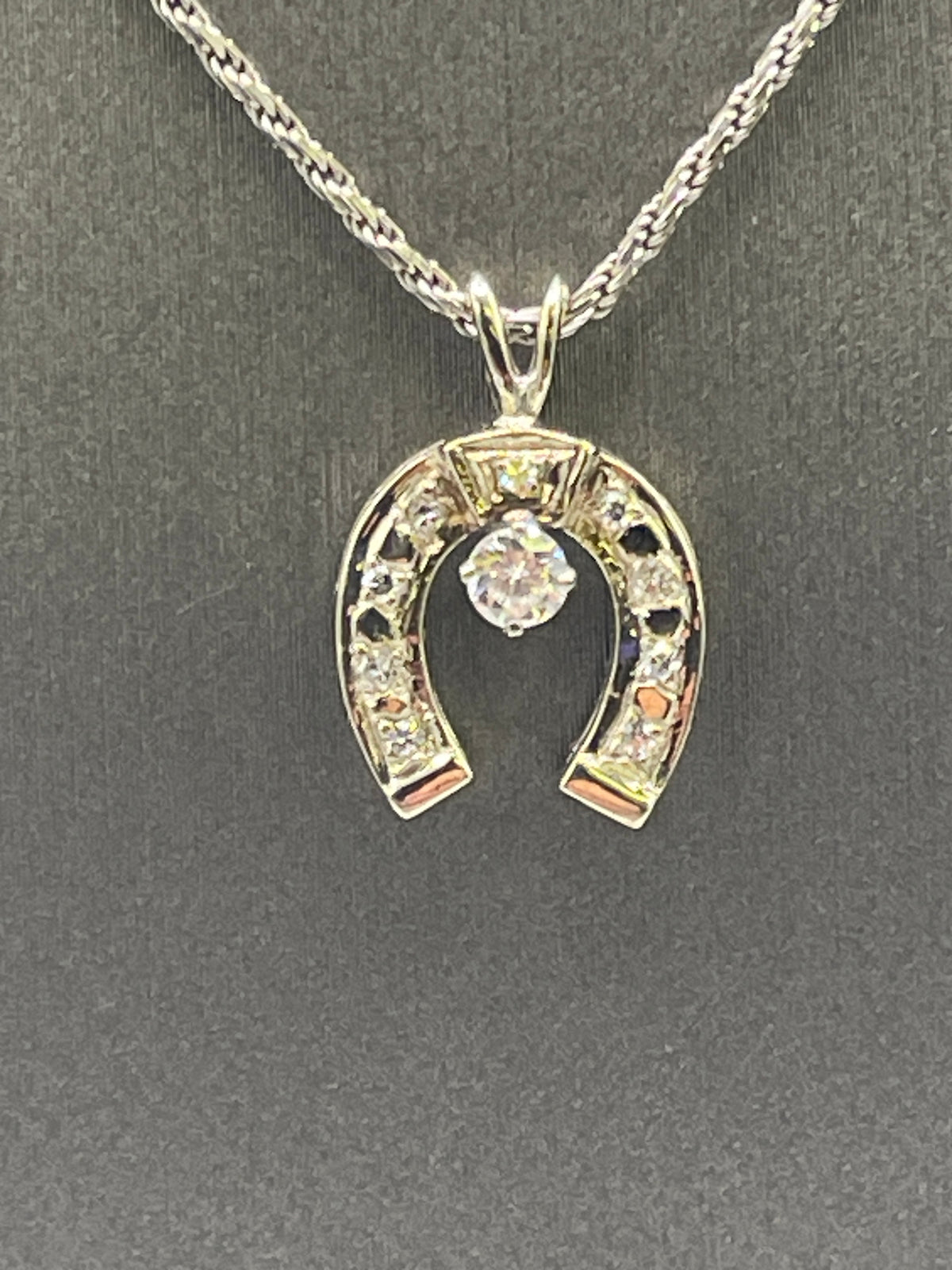 A Classic 14 Karat White Gold Diamond Horseshoe Pendants