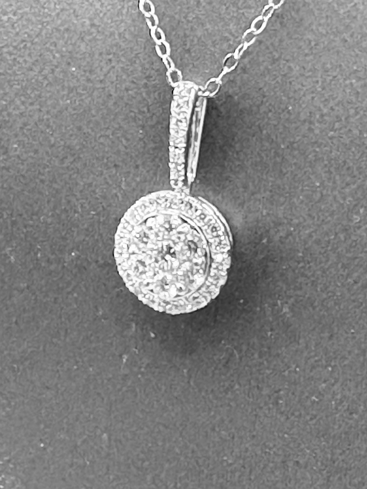 14kt solid white gold,  ladies diamond cluster pendant with diamond halo and diamond bale, hanging from a 16’’ pendant chain