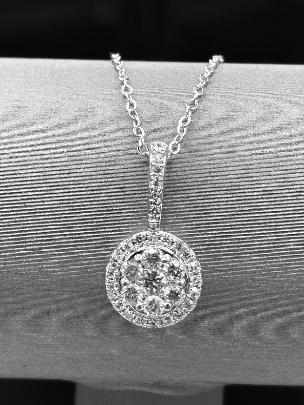 14kt solid white gold,  ladies diamond cluster pendant with diamond halo and diamond bale, hanging from a 16’’ pendant chain
