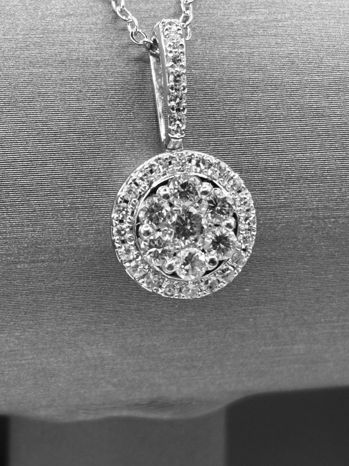 14kt solid white gold,  ladies diamond cluster pendant with diamond halo and diamond bale, hanging from a 16’’ pendant chain