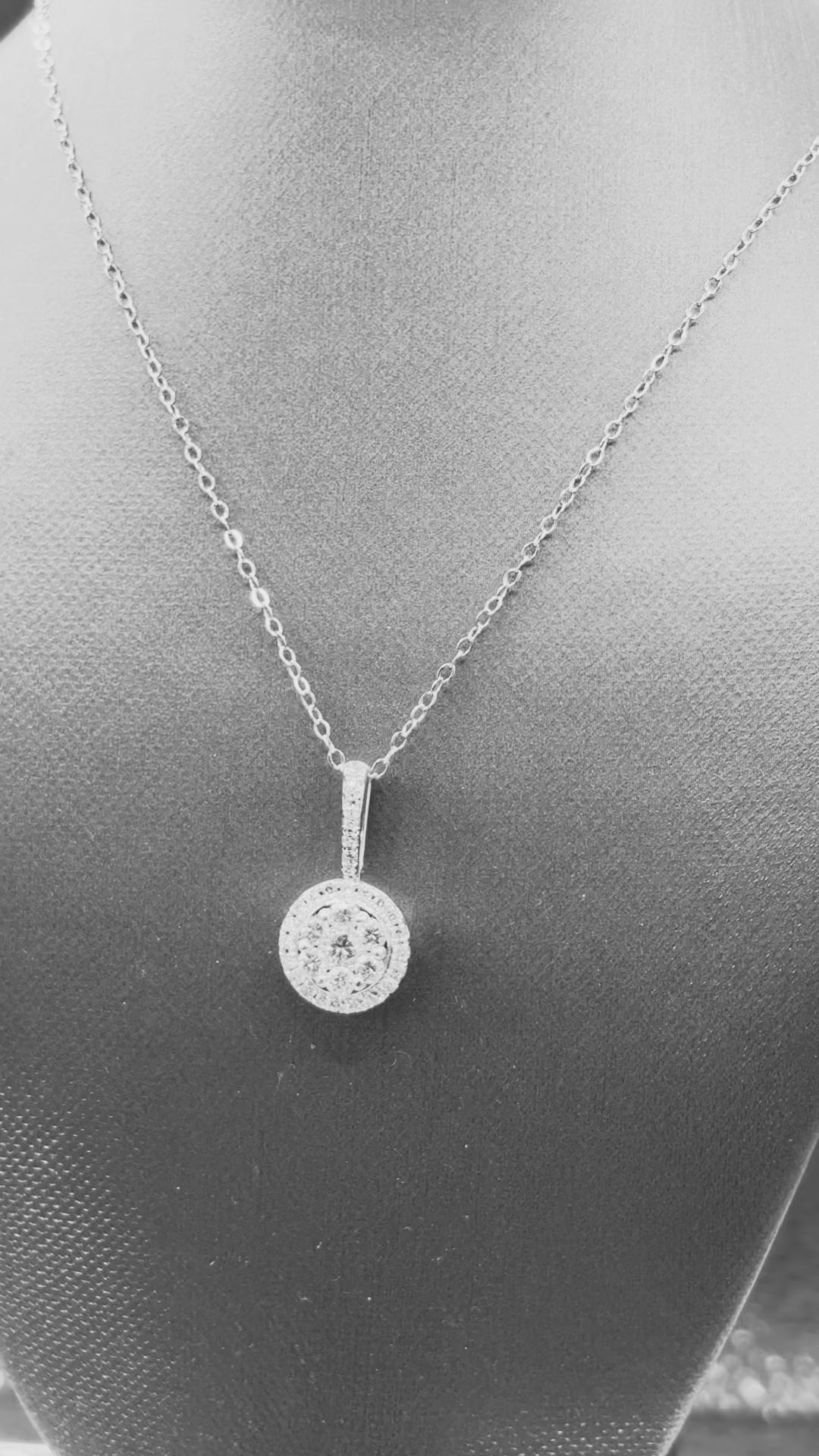 14kt solid white gold,  ladies diamond cluster pendant with diamond halo and diamond bale, hanging from a 16’’ pendant chain