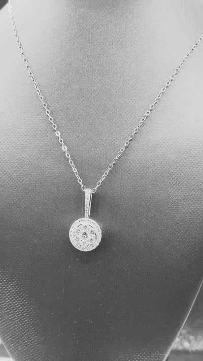 14kt solid white gold,  ladies diamond cluster pendant with diamond halo and diamond bale, hanging from a 16’’ pendant chain