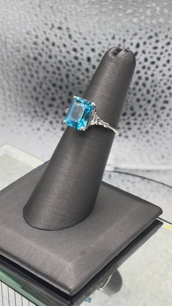 Ladies 10 Karat White Gold Emerald Cut Blue Topaz Ring
