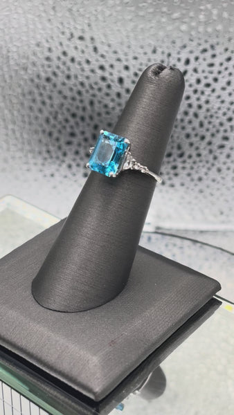Ladies 10 Karat White Gold Emerald Cut Blue Topaz Ring