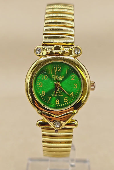 Vintage Womens gold-tone wristwatch features a stretch band and green dial