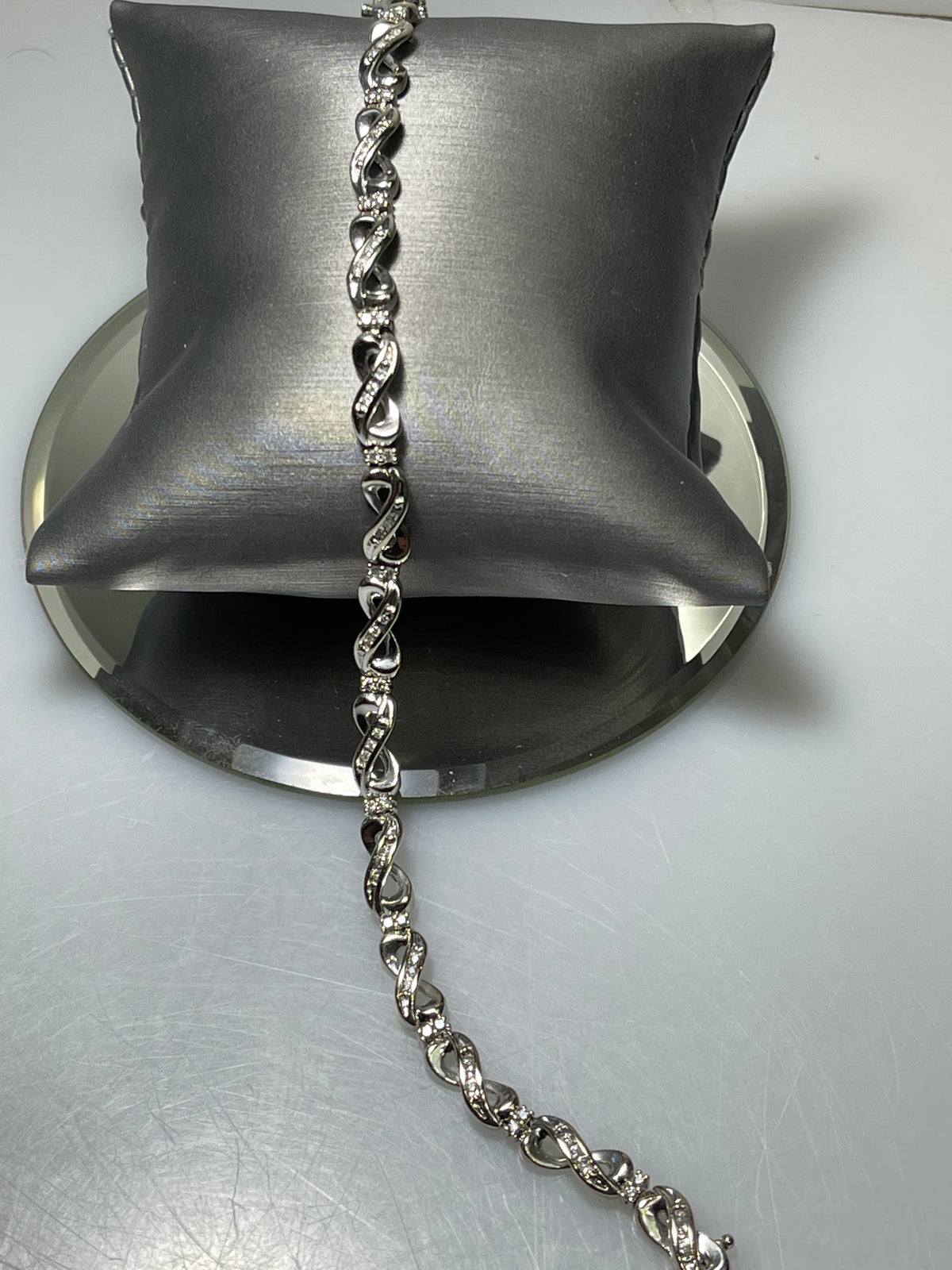 A Ladies 10 Karat Gold Diamond Infinity Bracelet