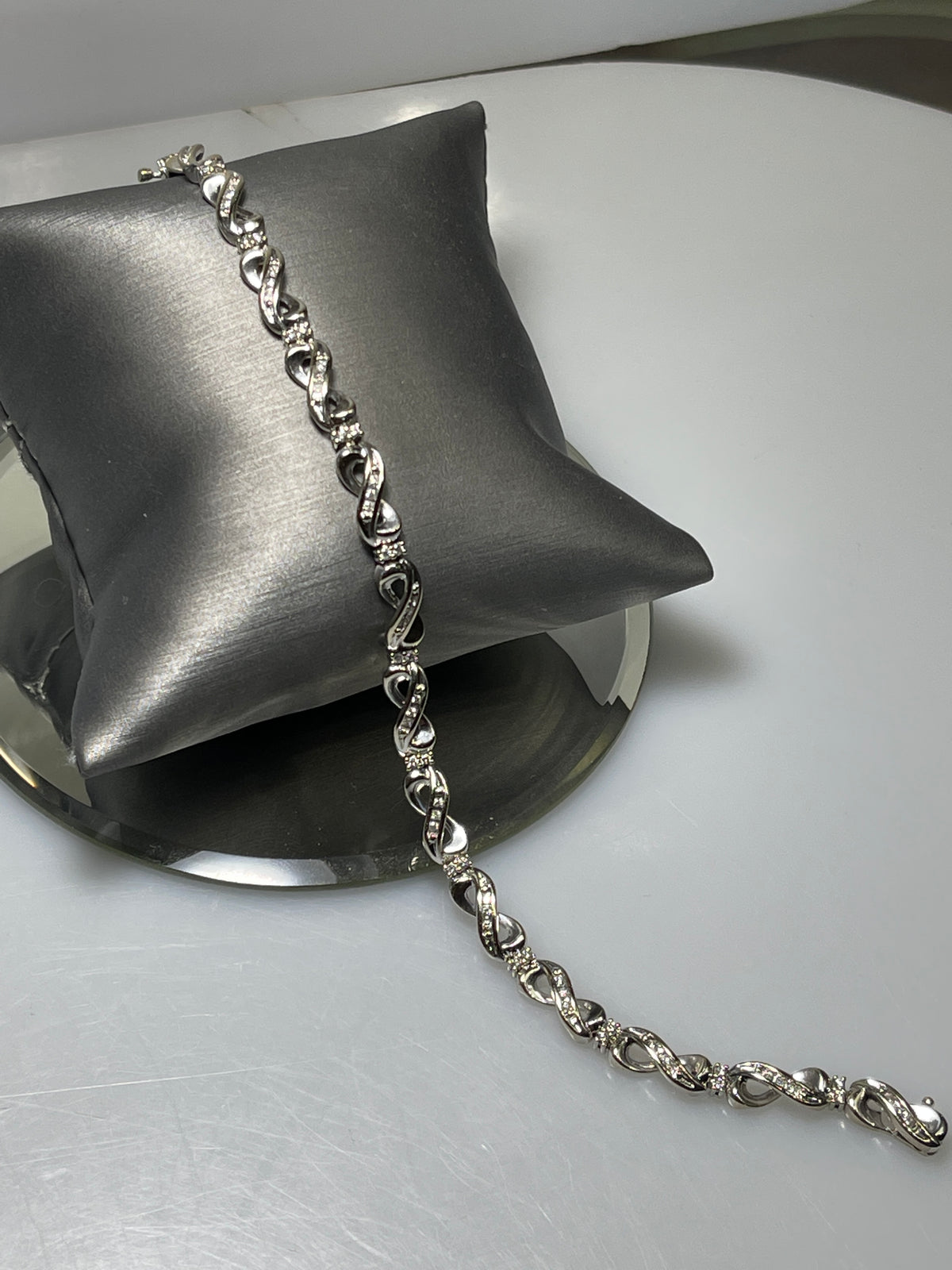 A Ladies 10 Karat Gold Diamond Infinity Bracelet