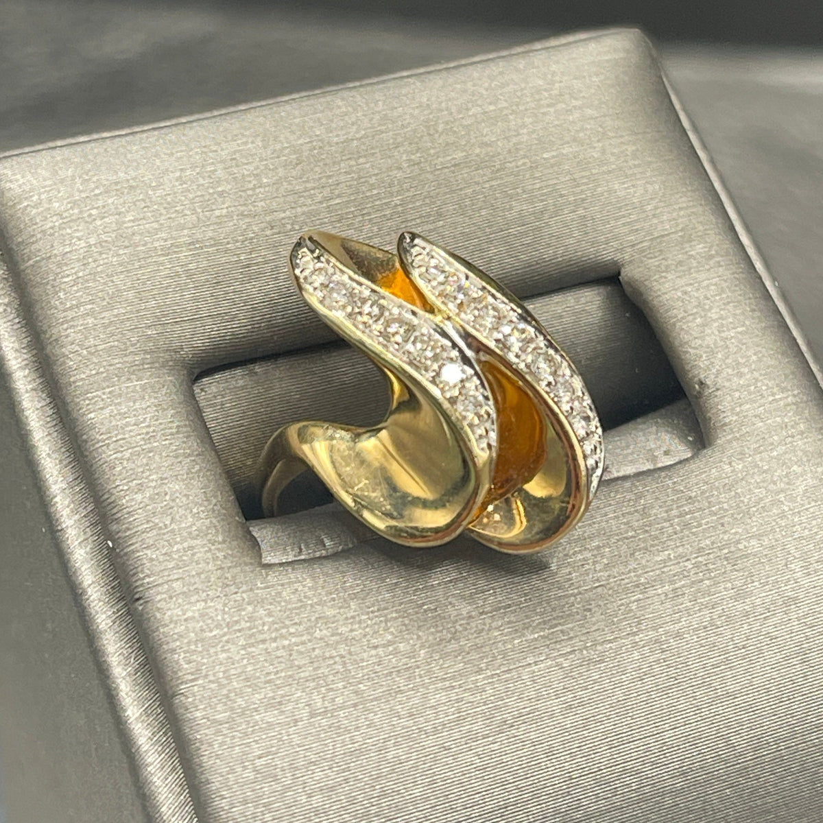 A Ladies 14 Karat Yellow Gold Double Diamond Swirl Cocktail Ring