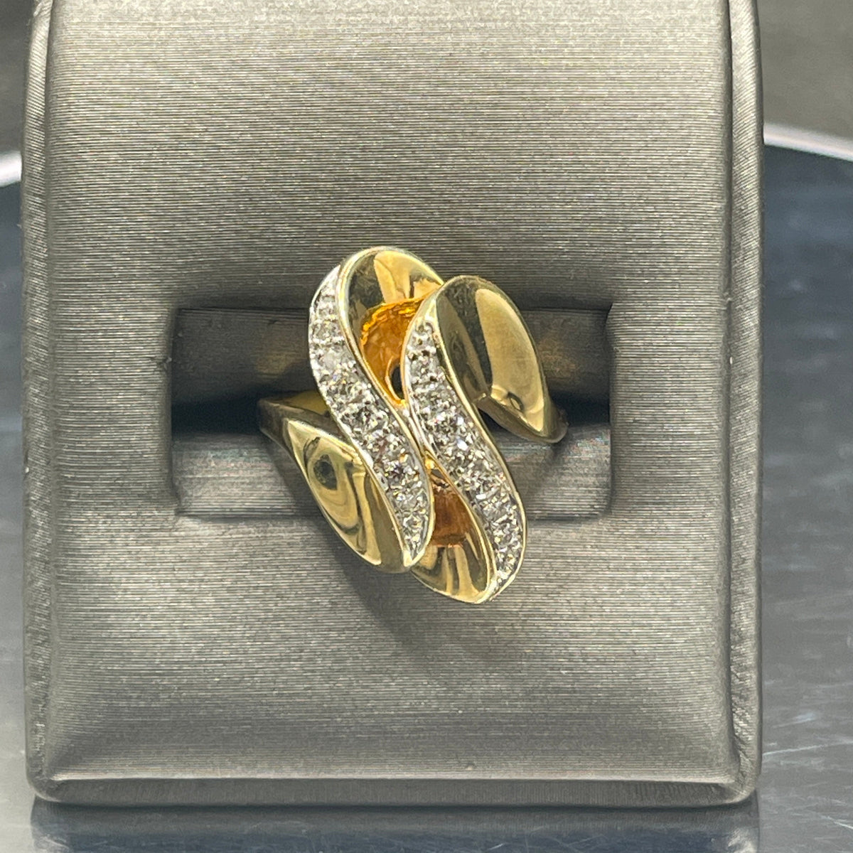 A Ladies 14 Karat Yellow Gold Double Diamond Swirl Cocktail Ring