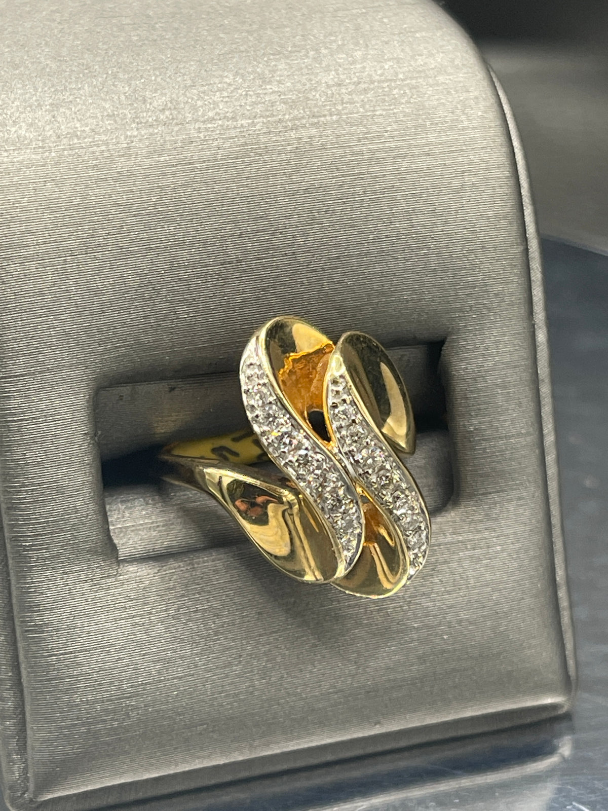 A Ladies 14 Karat Yellow Gold Double Diamond Swirl Cocktail Ring