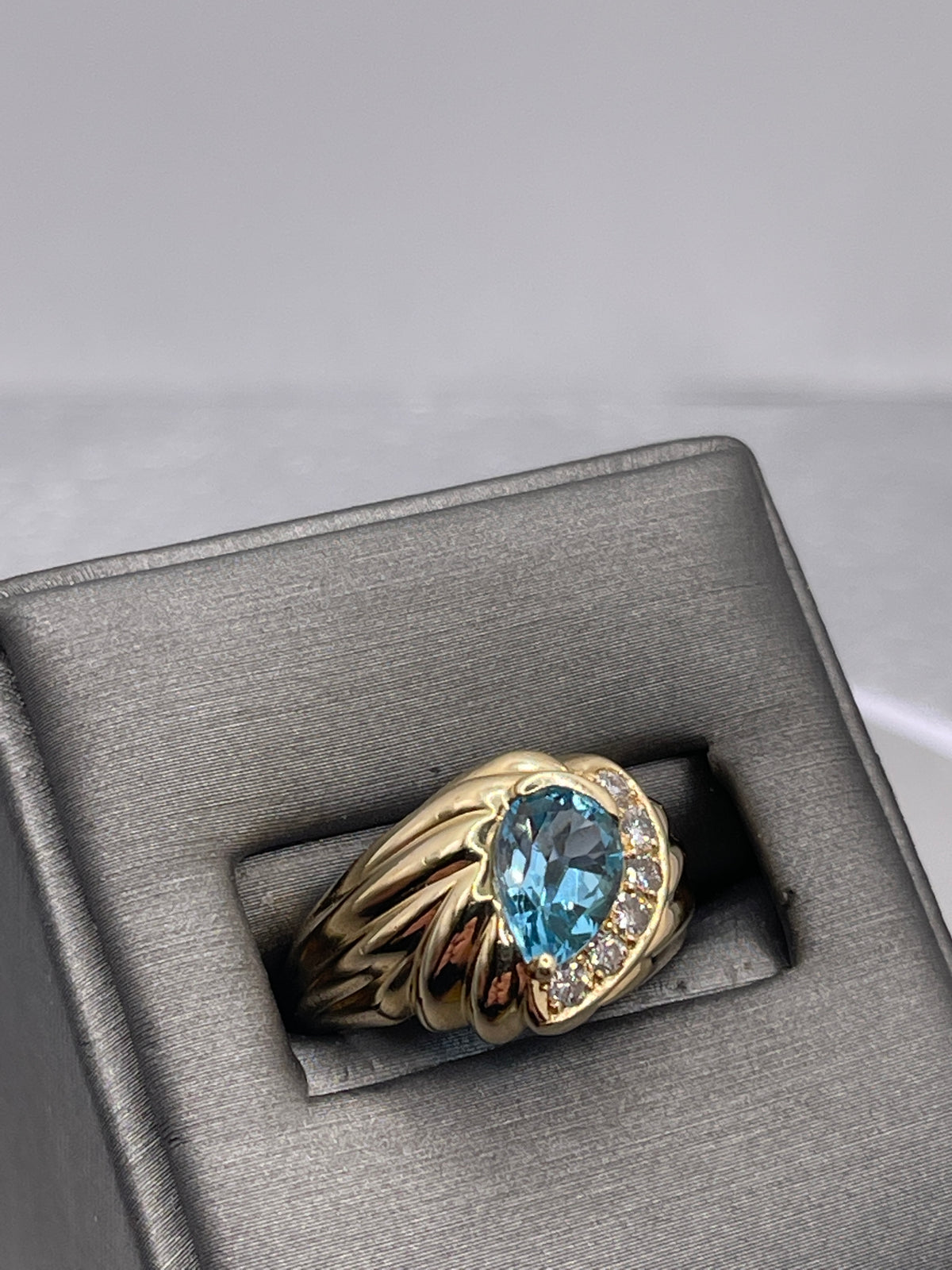 14 Karat Yellow Gold Fluted Band Pear Shaped Blue Topaz And Diamond Ring