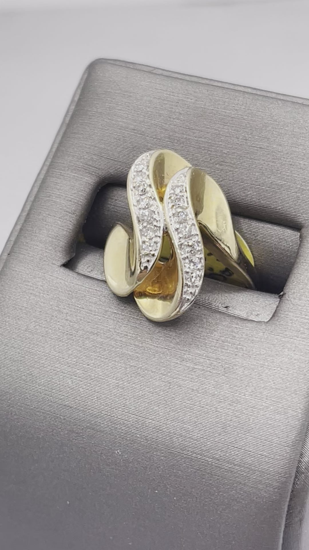 A Ladies 14 Karat Yellow Gold Double Diamond Swirl Cocktail Ring
